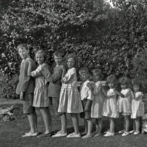 Family of ten children standing in a line