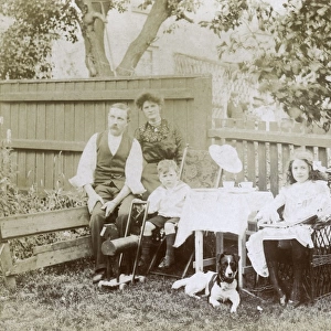 Family of four and a dog in a garden