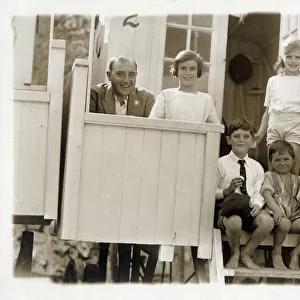 Family outside their beach hut