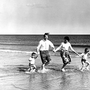 Family of four paddling in the sea