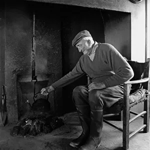 A farmer sits in the farm kitchen, Co Clare, Ireland