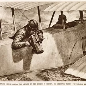 A German observer taking aerial photographs using a pistol-camera over the side of his