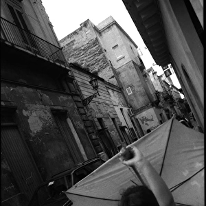 Girl in street with umbrella - Lecce, Italy