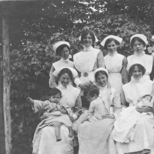 Group of nurses and children outdoors
