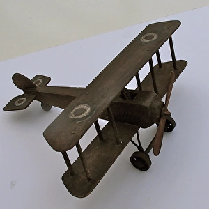 A hand-made wooden model of a WWI biplane
