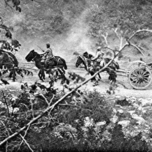 A heavy gun battery moving uphill during the Balkan campaign