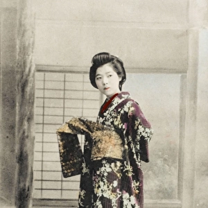 Japanese Geisha girl getting dressed