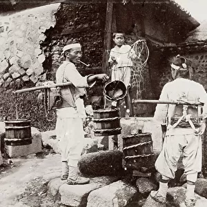 Korea: men taking water from a well