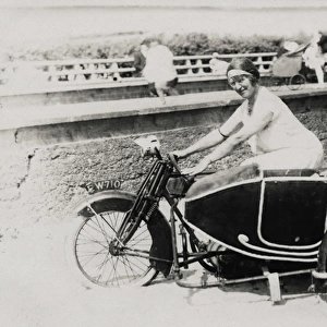 Two ladies on an early 1900s AJS motorcycle & sidecar