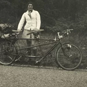 A lady kitted out for a cycling trip in warm coat and long socks standing alongside a