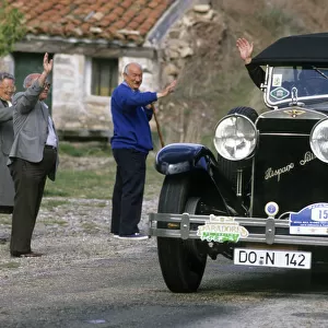 Local people wave to driver of a vintage Hispano Suiza car