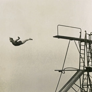 Man diving into an outdoor pool at a seaside resort