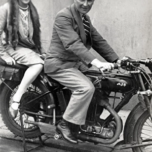 Man & lady on a 1926 / 7 AJS motorcycle