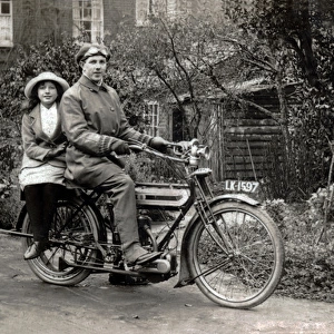 Man & young girl on a 1911 Triumph motorcycle
