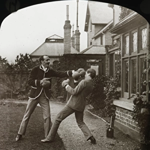 Two men in boxing gloves outside a house