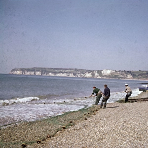 Men with fishing nets at Seaton, Devon