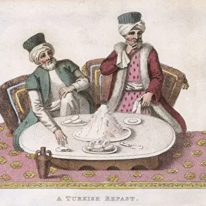 Two men having a Turkish breakfast of yogurt and buns