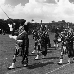 Men of the Oban Pipe Band, playing their bagpipes at the Highland Games, Tobermory