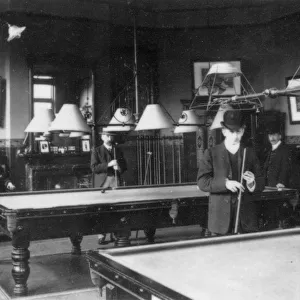 Men playing billiards in a club