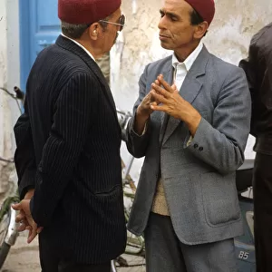 Two men talk in the street in Houmt Souk, Djerba, Tunisia