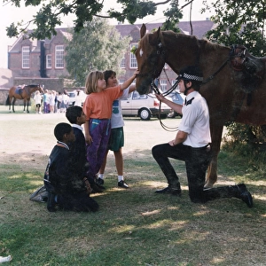 Metropolitan Police officer with horse and children