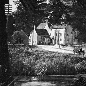 Morris Minor driving through English village