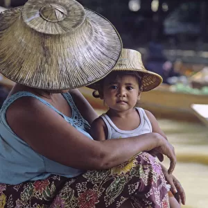 Mother and child wearing traditional Thai hats, or ngobs