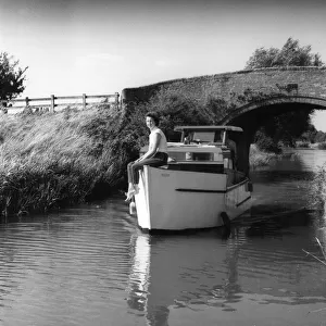 A motor cruiser on a quiet and peaceful stretch of the Oxford Canal, near Claydon