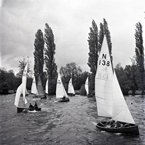 National 12 sailing dinghies on a Devon river