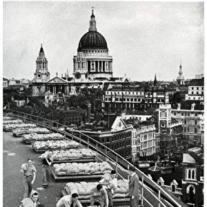 Outbreak of WWII Sandbagging flat roof of an office building