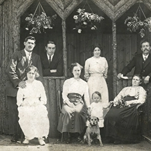 Eight people with a dog in a garden