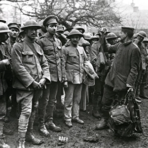 Portuguese prisoners handing over gas masks, WW1