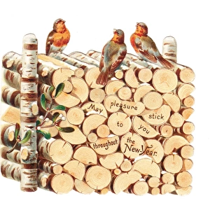 Robins perched on a pile of logs on a cutout New Year card