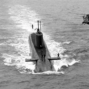 A Royal Navy Sea King alongside a submarine
