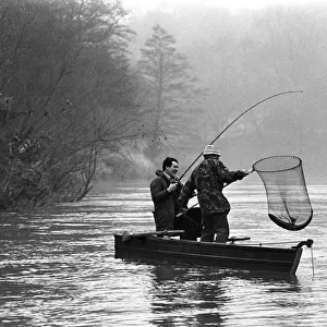 Salmon fishing with ghillie from a boat on the River Wye