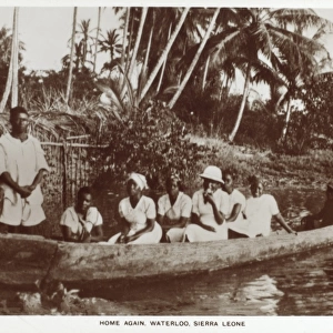Sierra Leone - Family in a log canoe