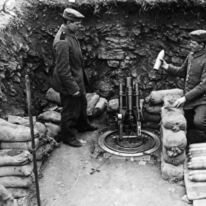 Two soldiers loading a mortar