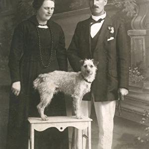 Studio portrait, couple with dog
