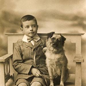 Studio portrait, little boy with his dog