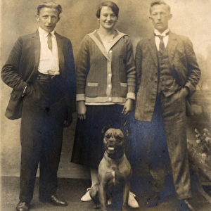 Studio portrait, three people with boxer dog