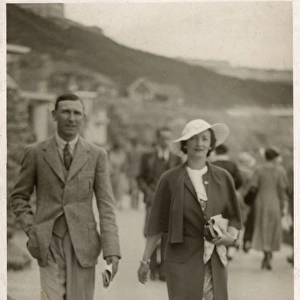 Stylish holiday couple in Scarborough walk along the beach