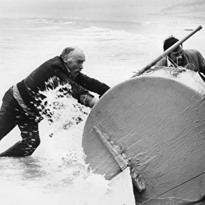 Ted McNamara retrieving barrel, Sennen Cove, Cornwall