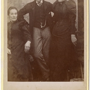 Two Victorian sisters and their brother in studio setting