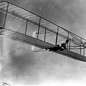 Wilbur Wright in the 1902 glider in flight