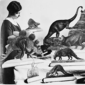 Woman with dinosaur models, 1926