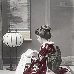 Woman in ornate kimono reading, Japan, c. 1880 s