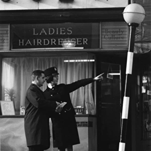 Woman police officer giving directions on a London street
