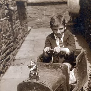 Young lad with a magnificent wooden toy car
