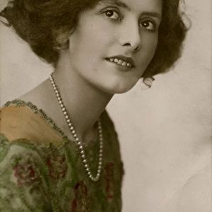 Young woman in green dress and pearl necklace