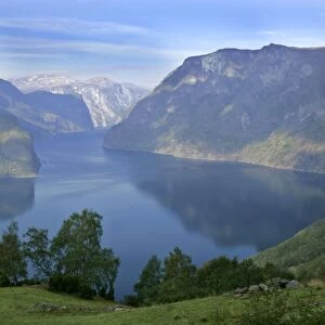 Aurlandsfjord framed by high mountains and green pastures Sogn og Fjordane, Norway
